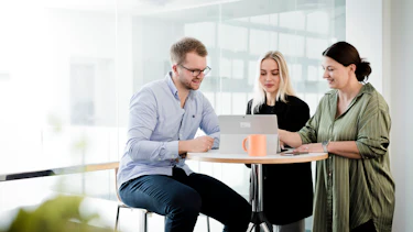 Meeting Three employees in a meeting