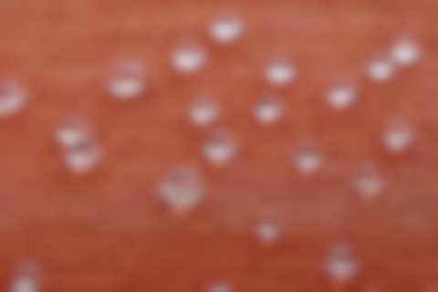 orange fabric with some water drops dripping off
