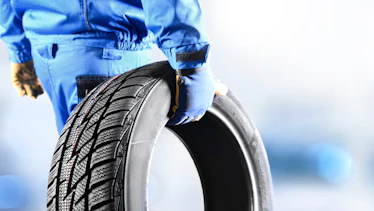 Mechanic holding tire Mechanic holding tire