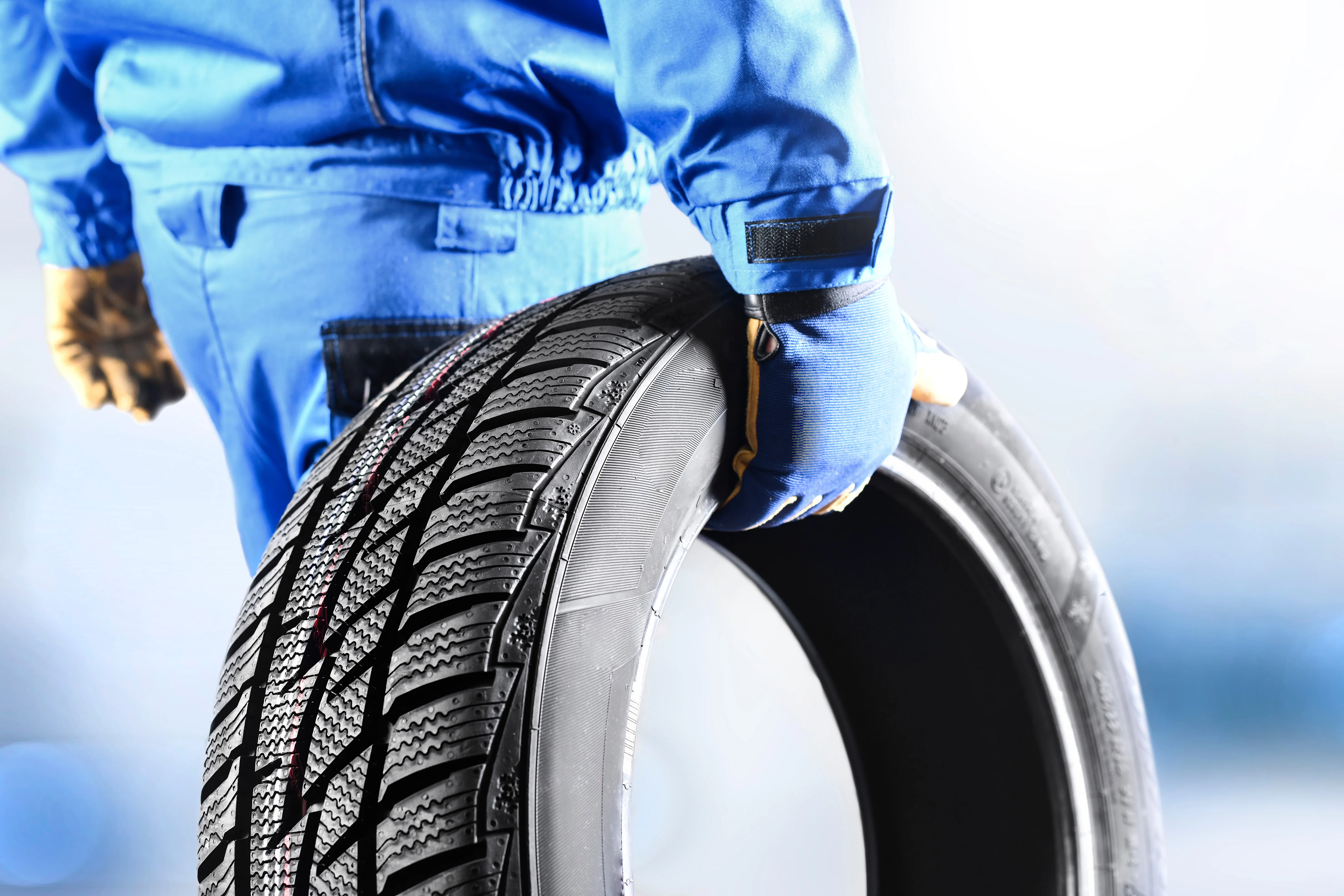 Mechanic holding tire Mechanic holding tire