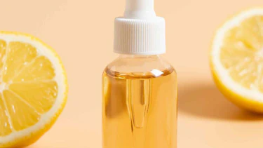 Serum in front of lemon halves Serum in front of lemon halves