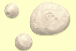 Three shiny gel bubbles on a pale yellow background Three shiny gel bubbles on a pale yellow background