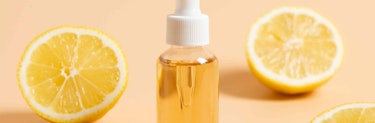 Serum in front of lemon halves Serum in front of lemon halves