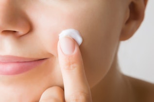 Woman applying cream Woman applying cream