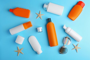 Various cosmetic containers in front of a blue background Various cosmetic containers in front of a blue background