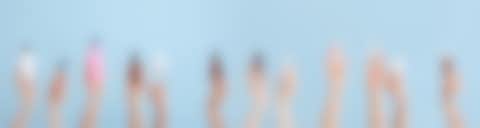 Cosmetic Products Hands with cosmetic products in front of a blue background