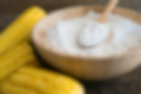Corn and a bowl of white powder Corn and a bowl of white powder
