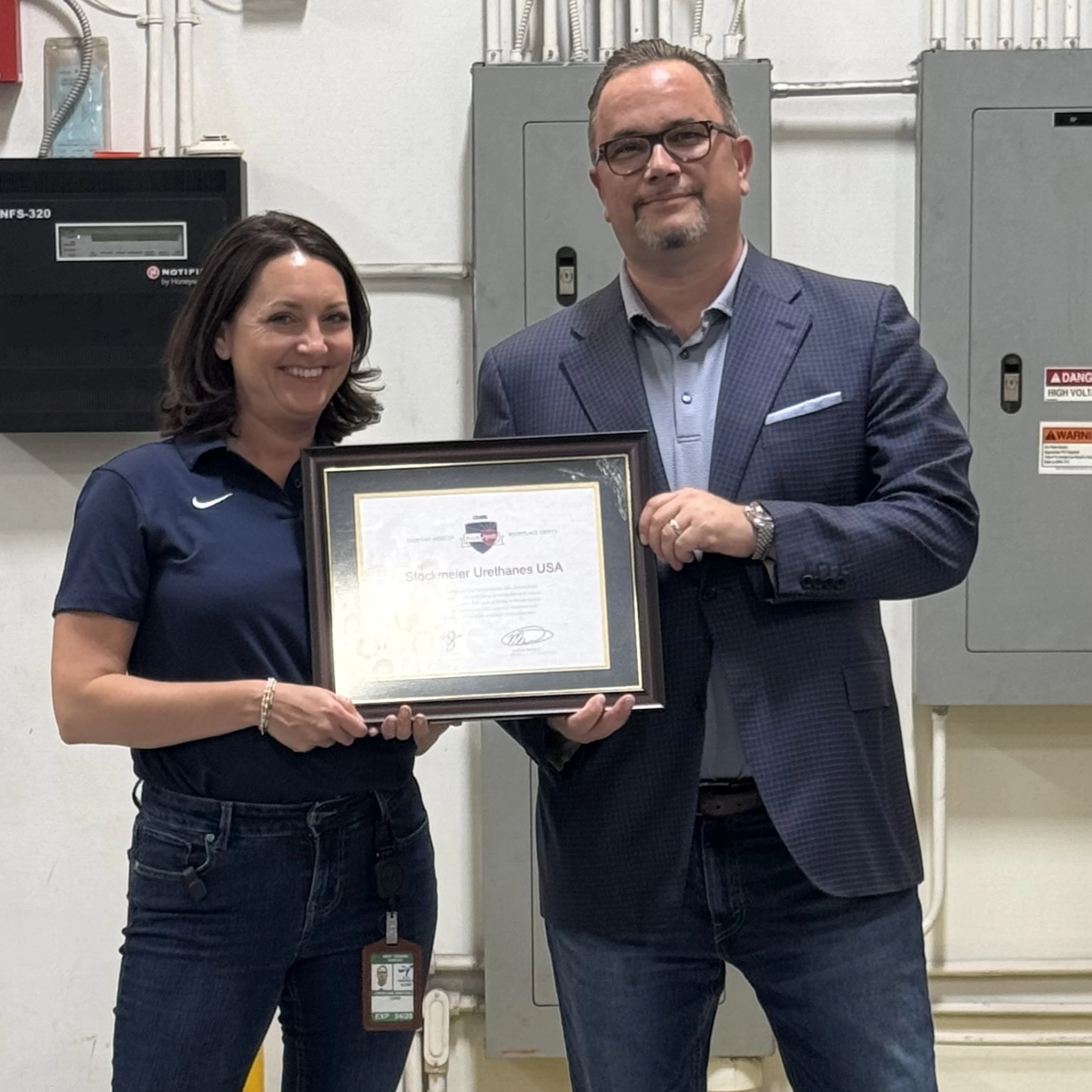 Pulse Award certificate, which is displayed in the company Chief Operations Officer and CEO of the USA site taking a photo with the company's Pulse Award certificate