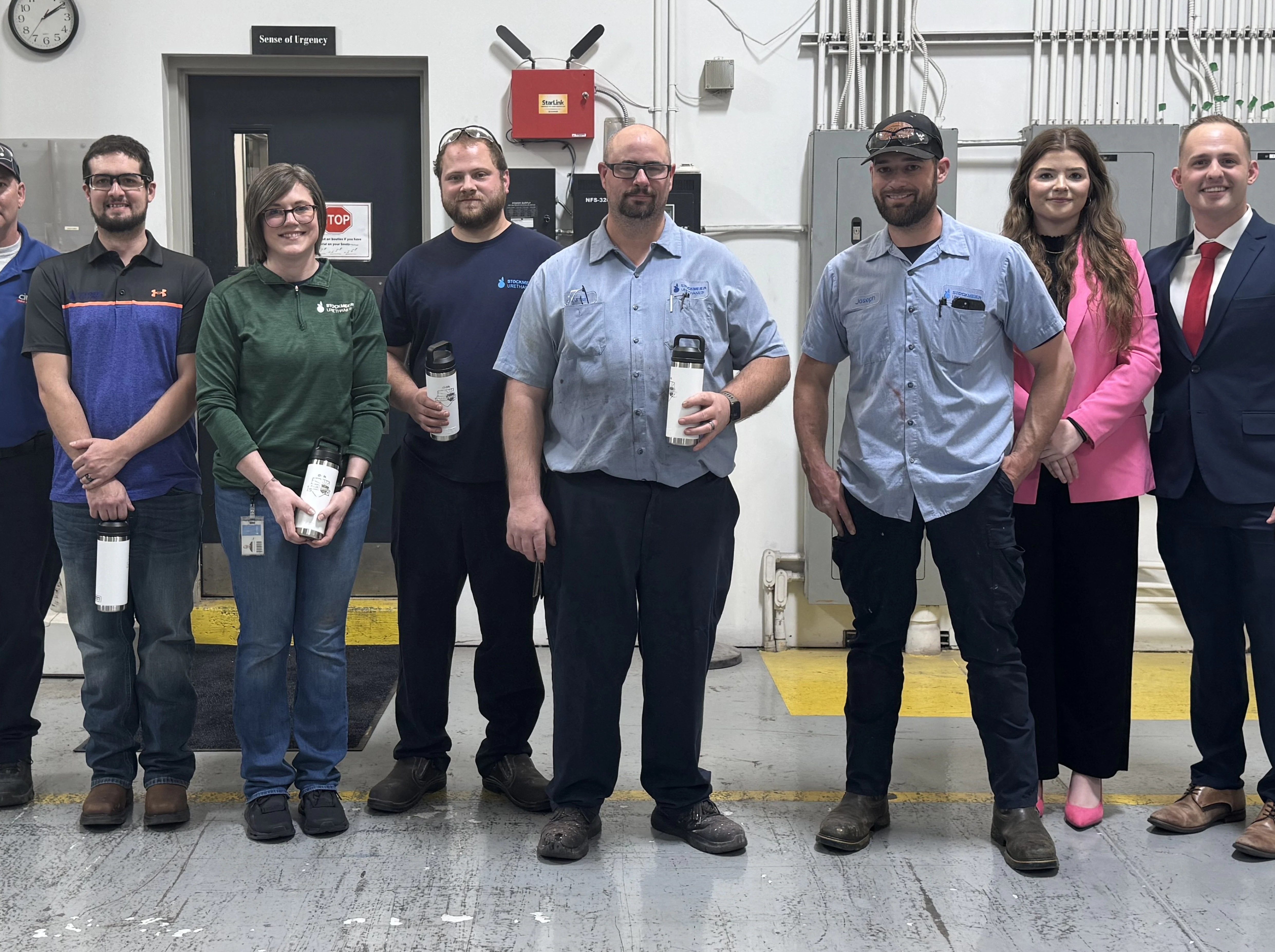 A group of USA employees receiving recognition awards presented by Cintas representatives A group including five STOCKMEIER Urethanes USA employees standing together with three Cintas employees receiving their recognition award