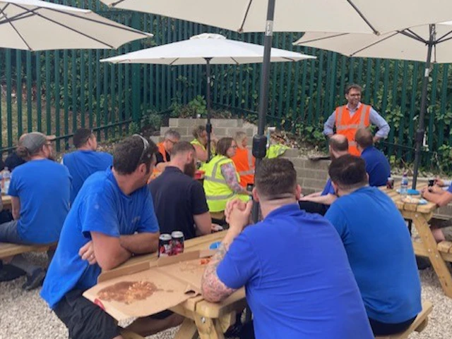 All employees sitting together and having lunch
