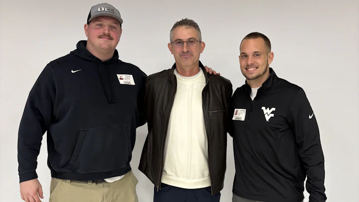 Group photo of Nick Malone, Christian Schaupp and Preston Fox standing in front of a wall