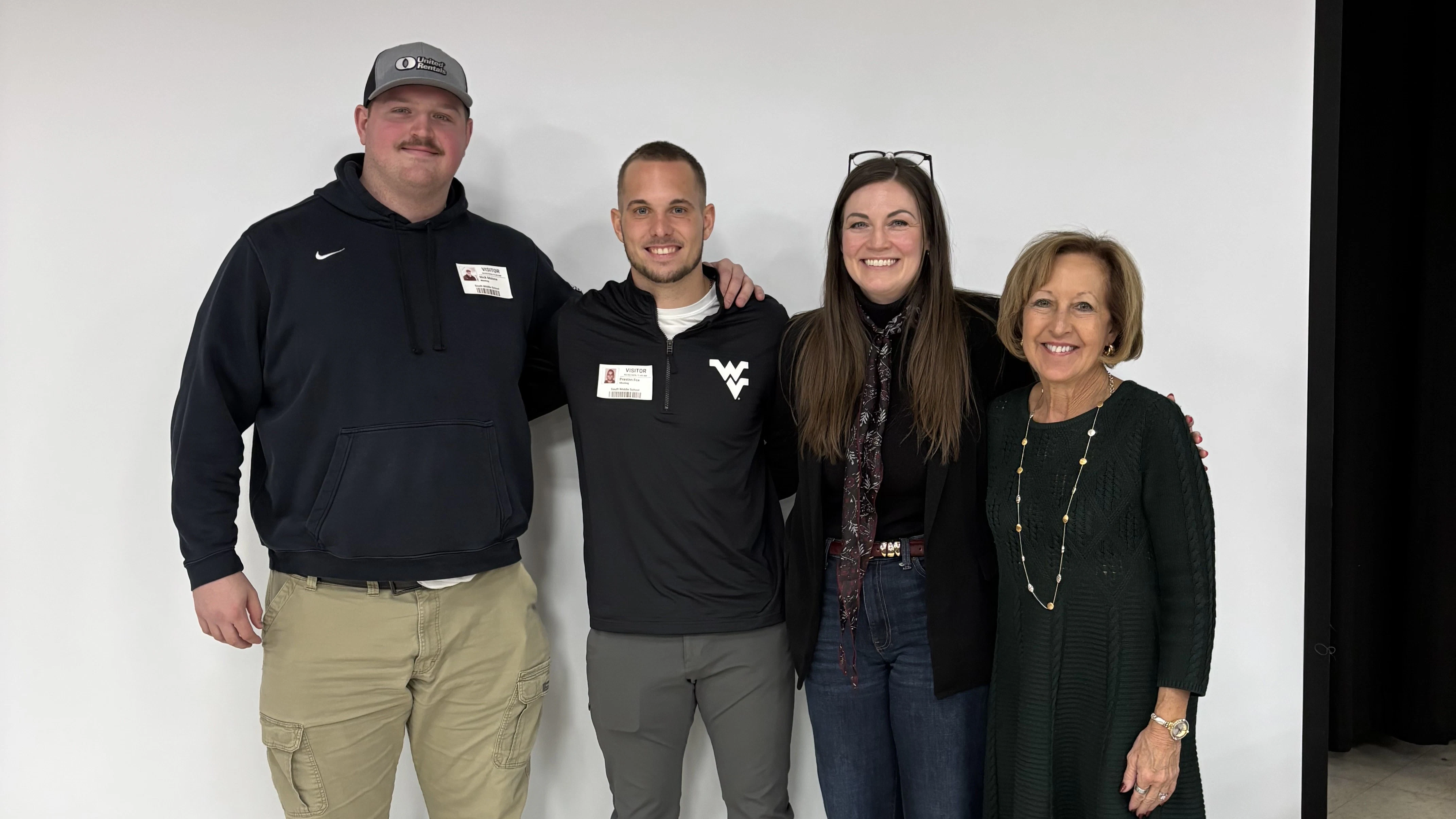 Nick Malone, Preston Fox, Lauren Underdonk (South Middle School counselor) and Donna Peduto (Executive Director, West Virginia Public Education Collaborative) Nick Malone, Preston Fox, Lauren Underdonk and Donna Peduto standing in front of a white wall