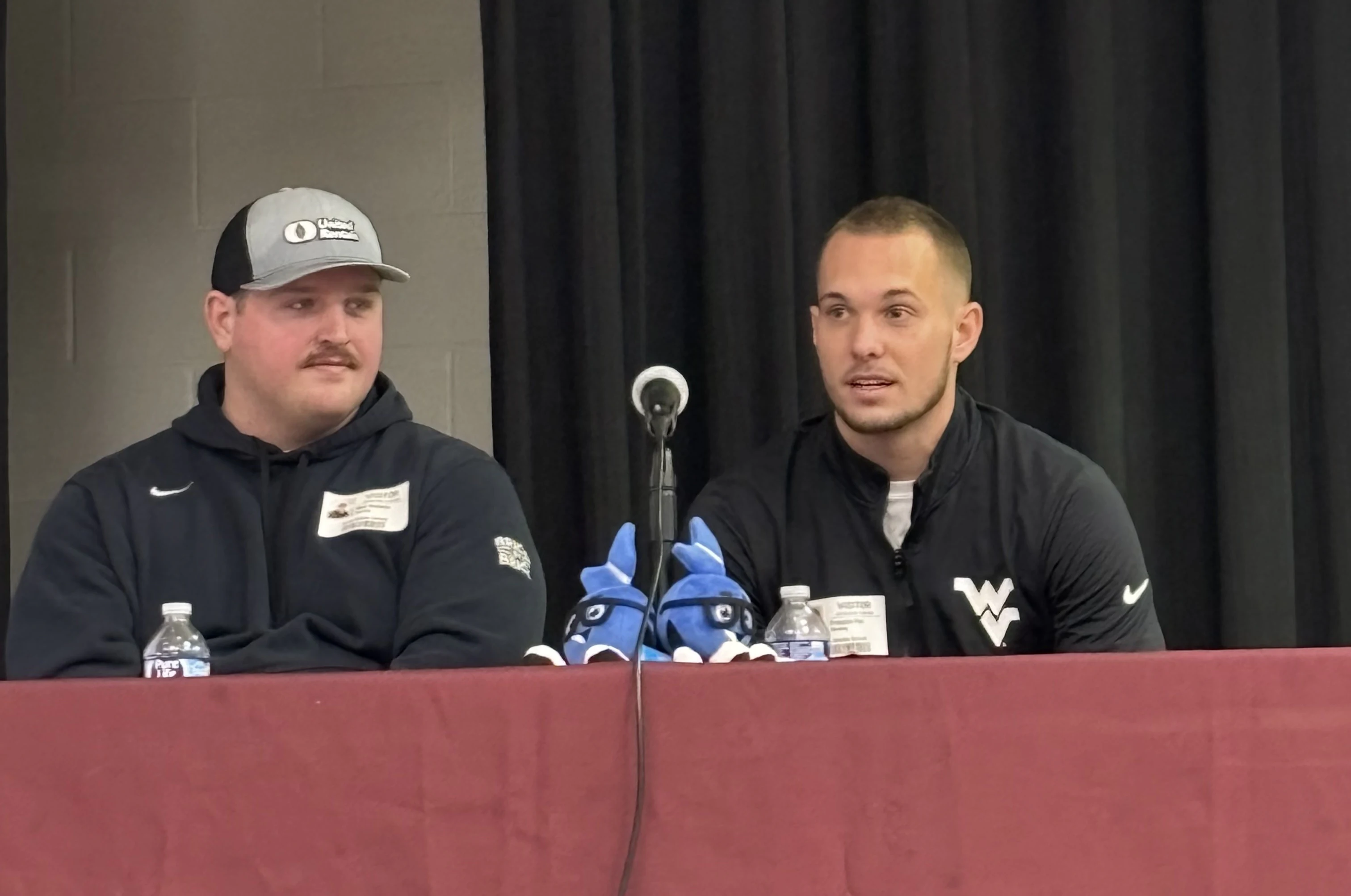 Nick Malone, STOCKMEIER Urethanes mascot Stobi, and Preston Fox talking to students Nick Malone, STOCKMEIER Urethanes mascot Stobi, and Preston Fox talking to students sitting at a table with a maroon tablecloth