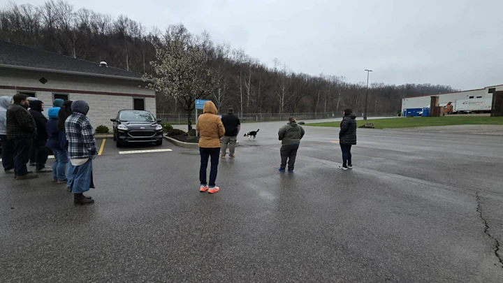 K9 Search & Rescue of West Virginia Inc at STOCKMEIER Urethanes USA in front of the building with people watching the dog perform in demonstration