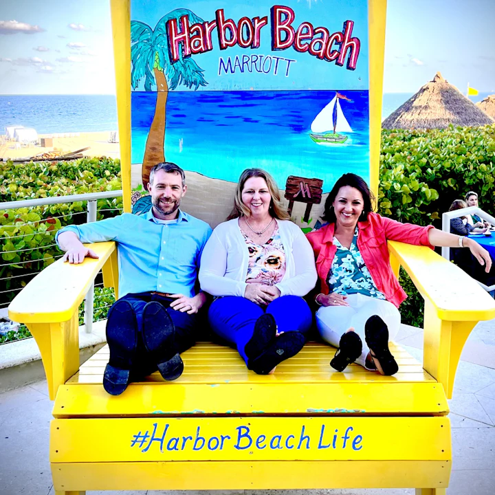 Three employees sit on a bench at the Responsible Care and Sustainability Conference